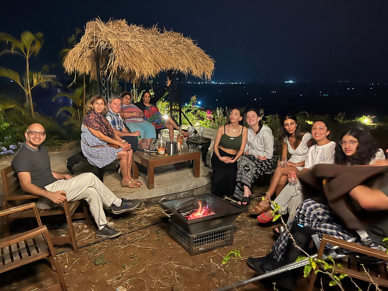 A group around the firepit at night