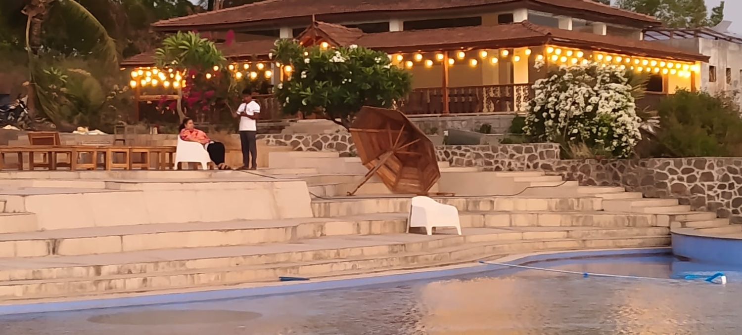 Pavilion and pool terrace with evening lights