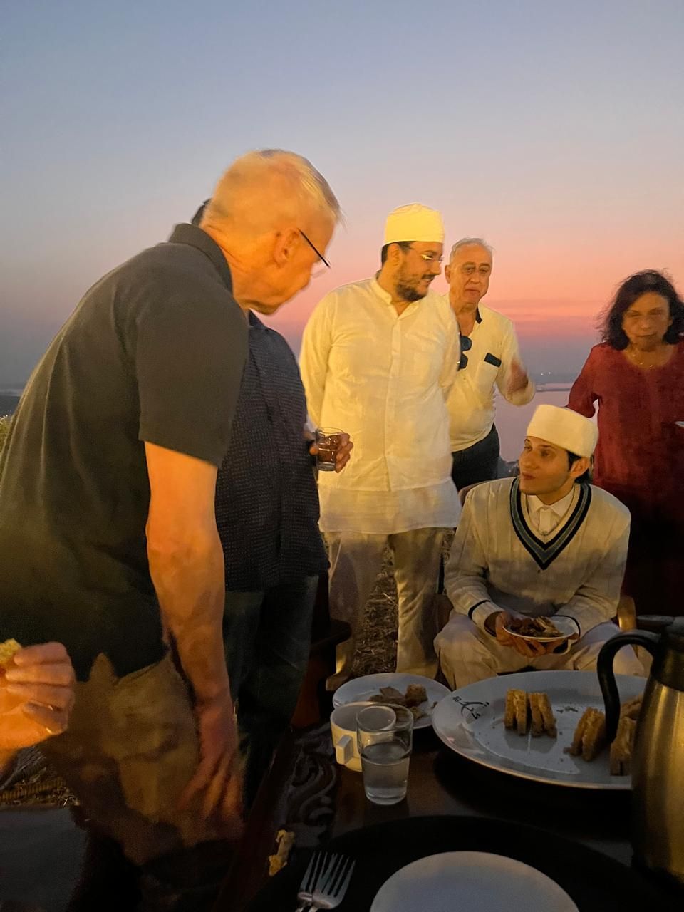 Guests sharing snacks at sunset
