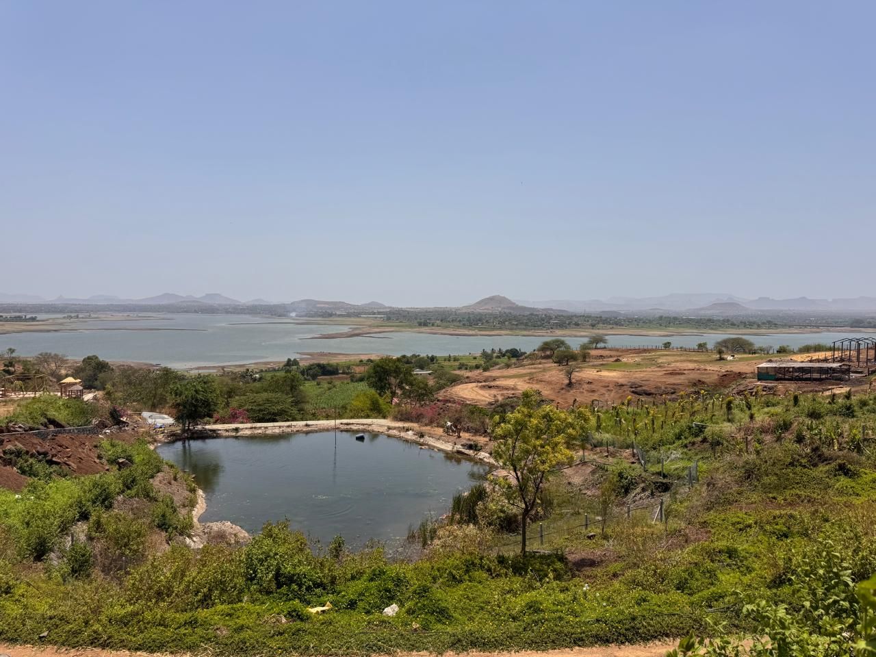 The natural pond with the lake beyond