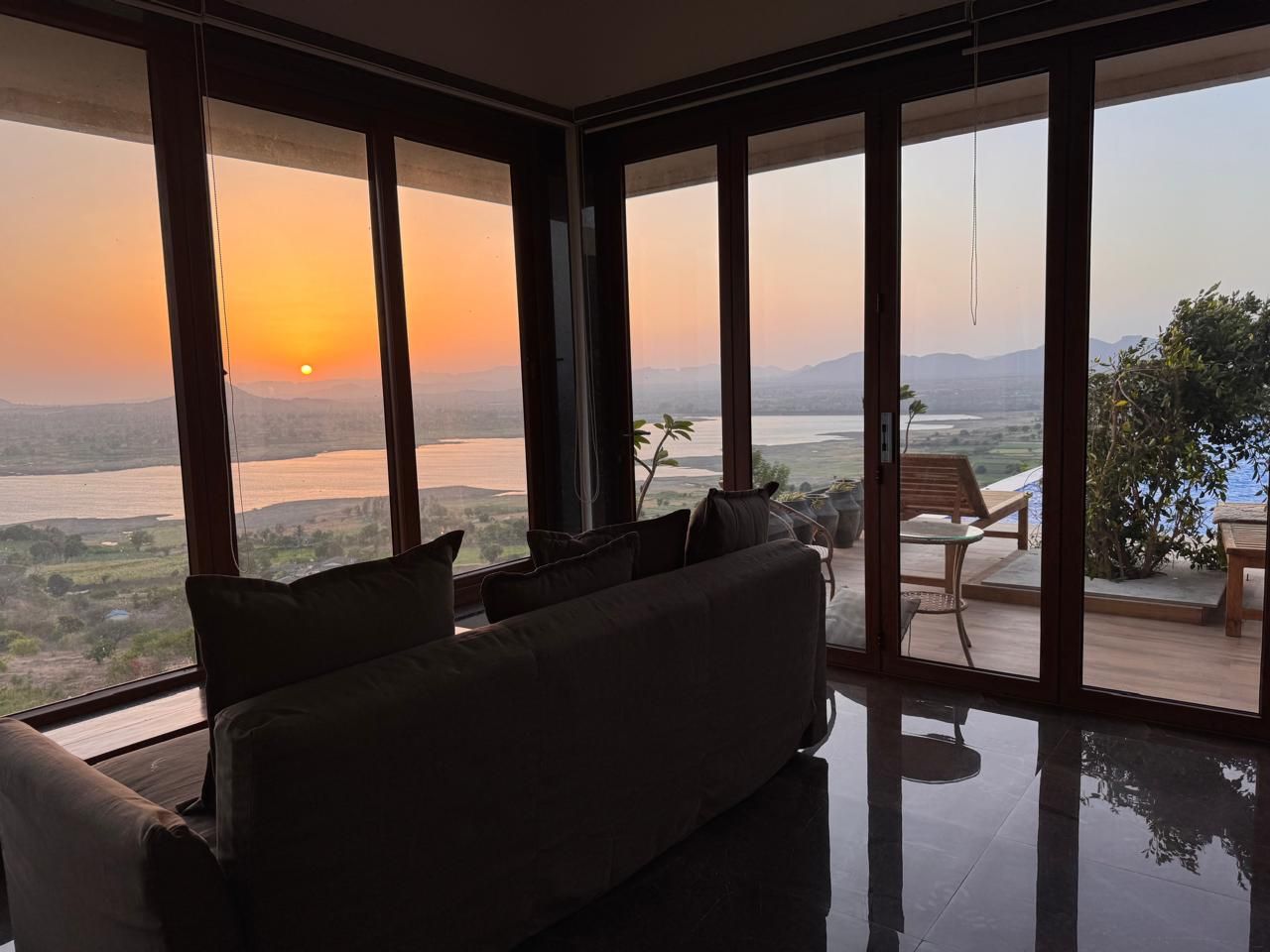 Living room looking straight out over the water at sunset